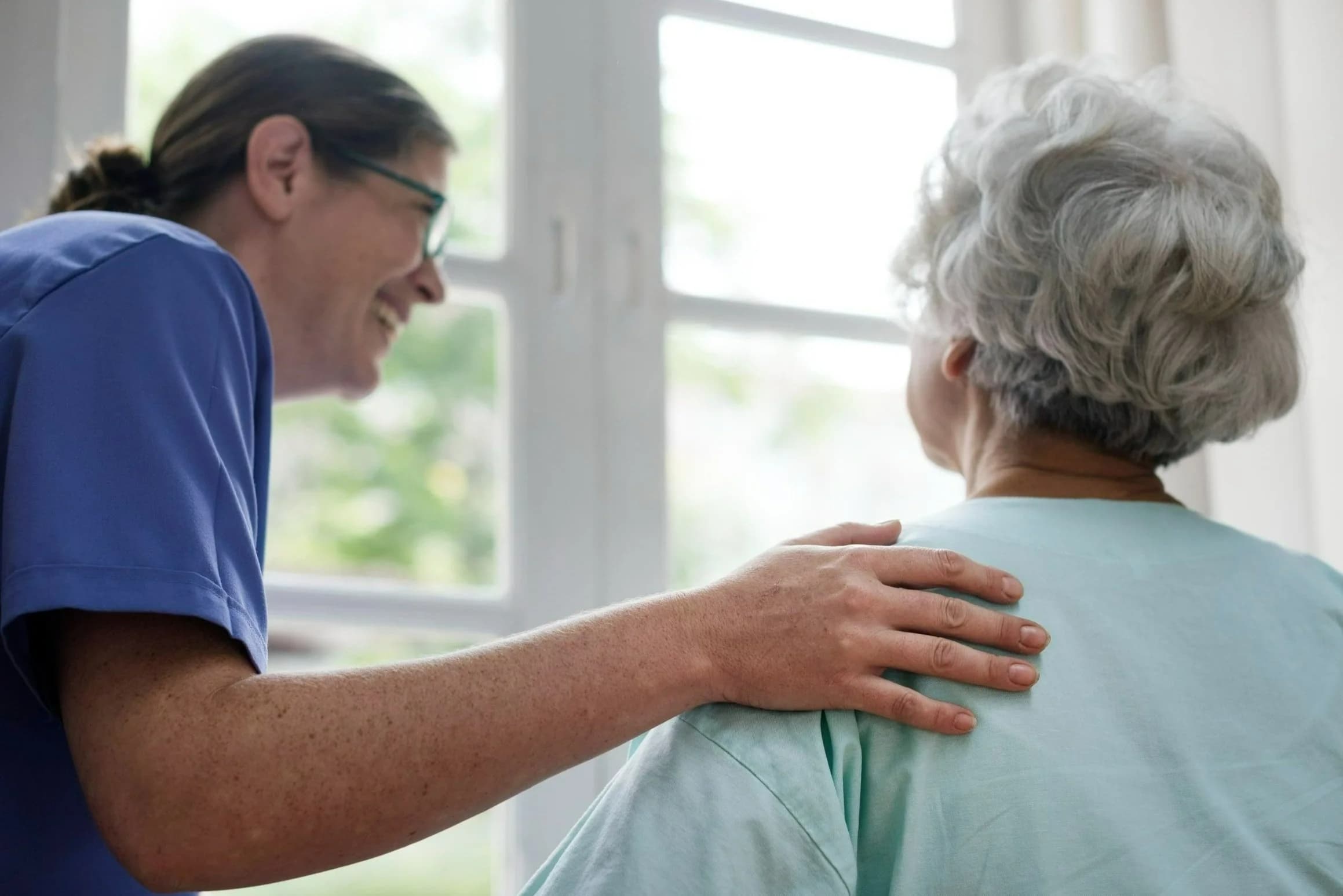 Caregiver providing compassionate support to a resident